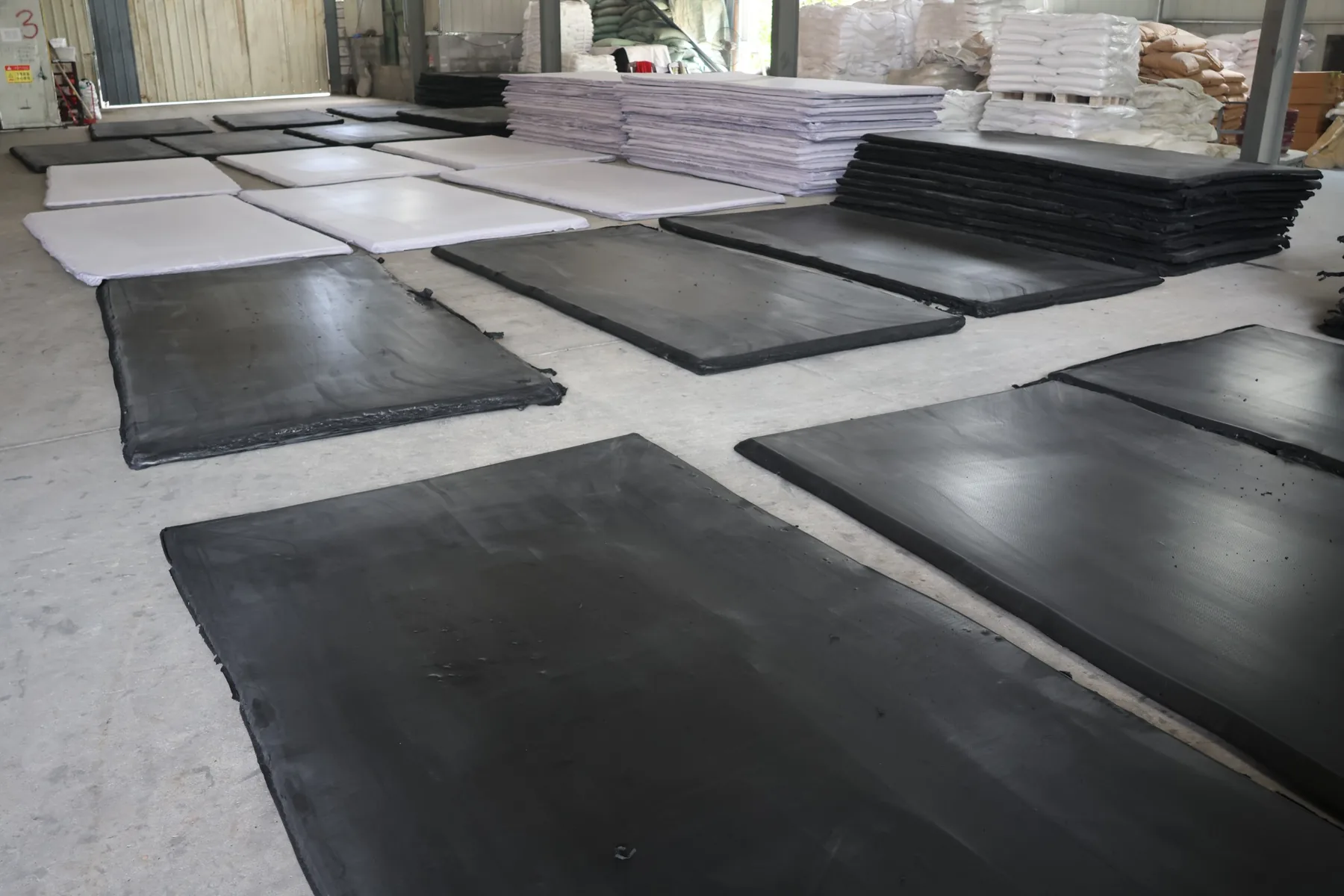 Black and white EVA foam slabs laid out in the workshop