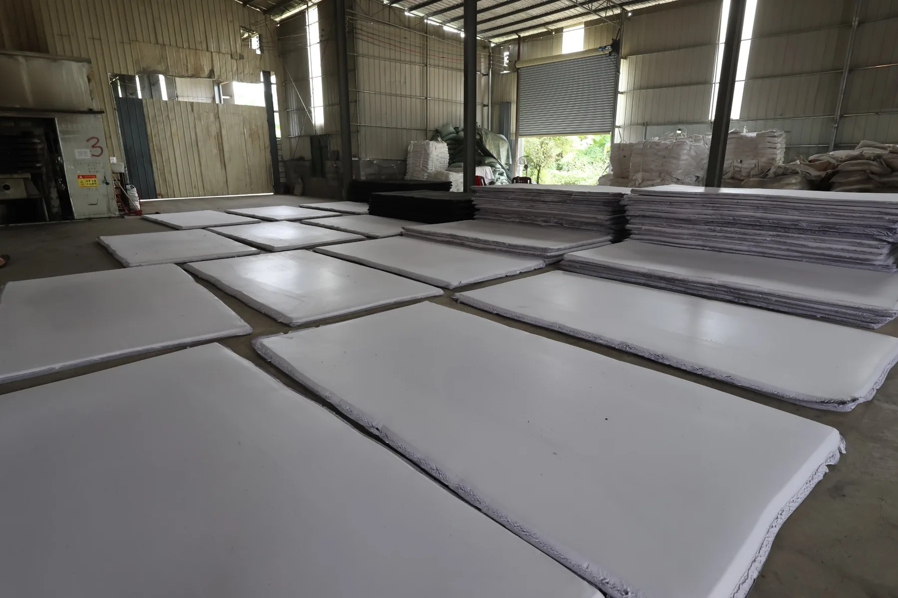 White EVA foam slabs laid out in the workshop